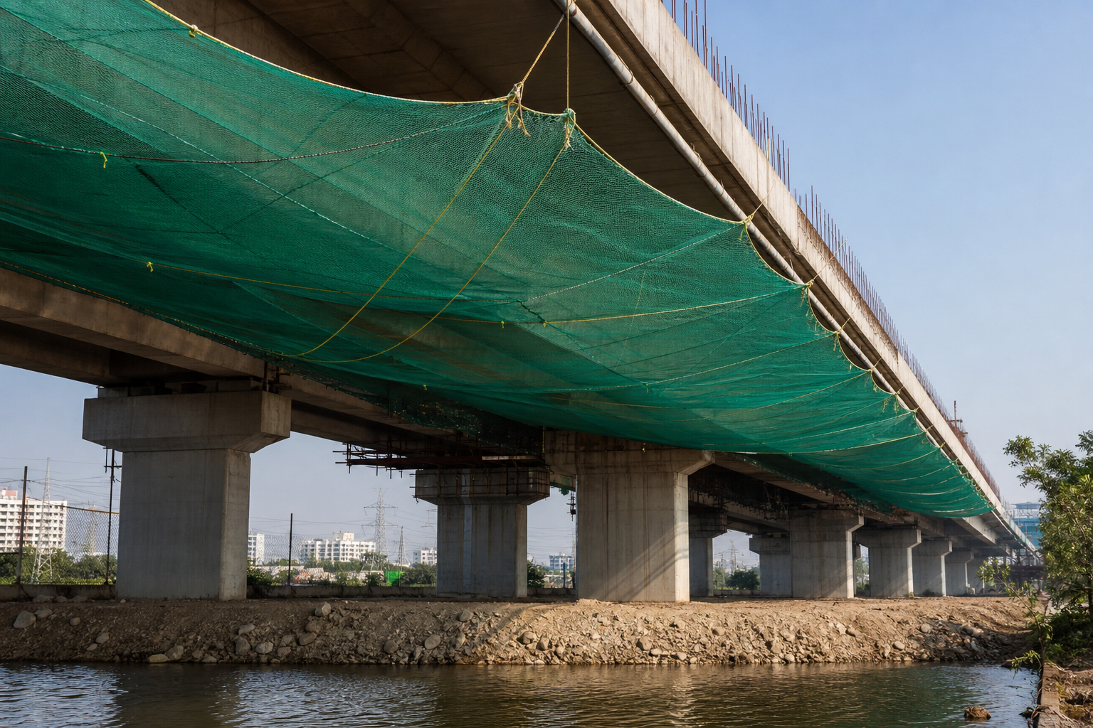 Construction safety net installed beneath a bridge work zone